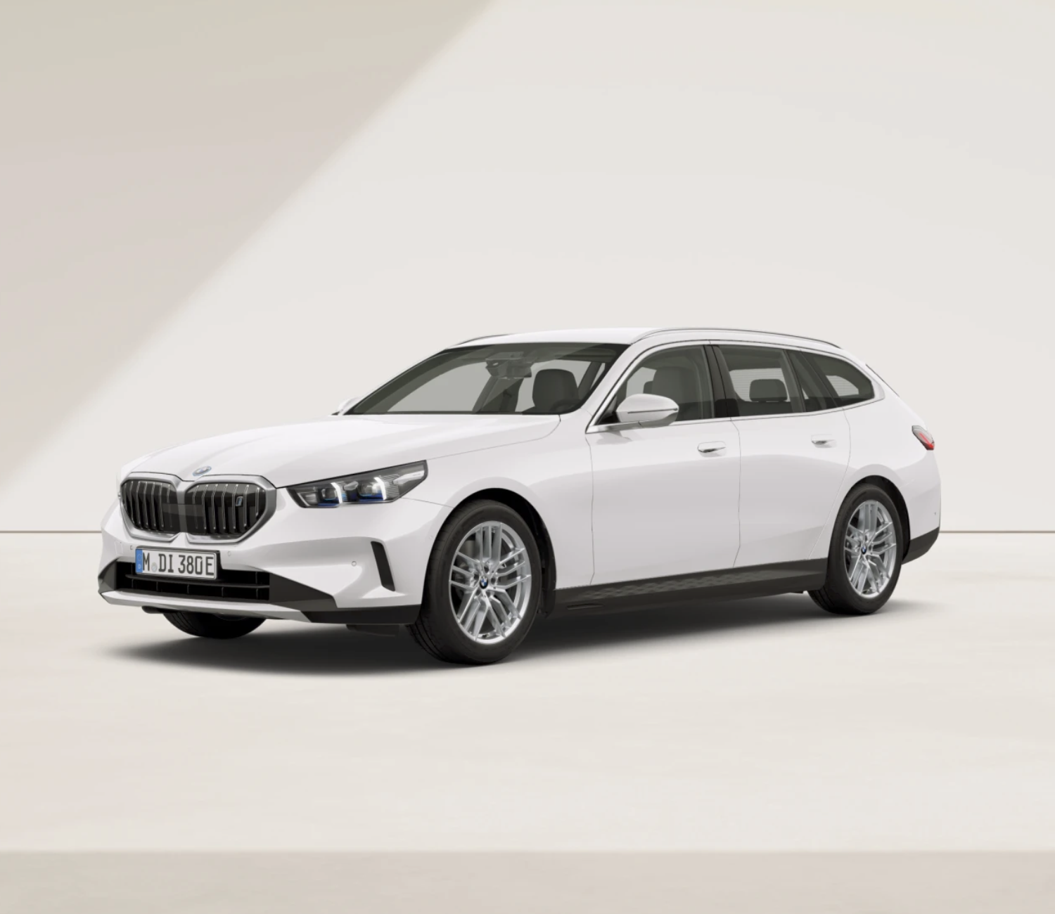 Weißer BMW i5 Touring vor beigen Wand. Bei Helming & Sohn gibt es die besten BMW Angebote.